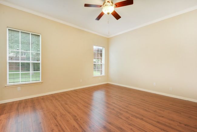 The spacious primary suite is a true retreat, complete with a luxurious bath featuring dual vanities, a walk-in shower, a soaking tub, and an oversized walk-in closet. | Image 21