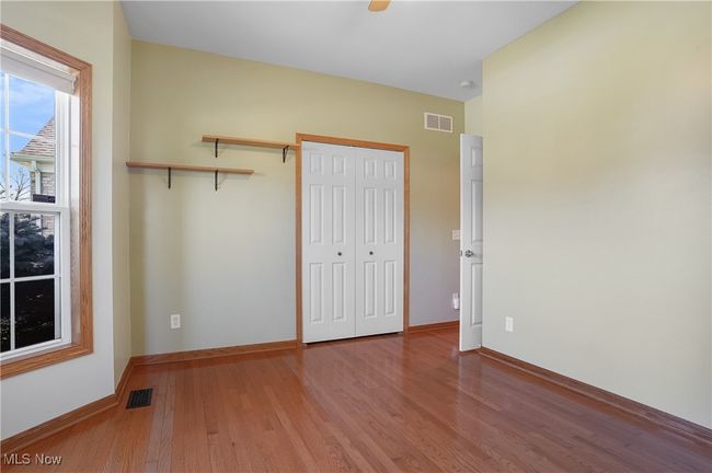 Unfurnished bedroom with baseboards, light wood-style flooring, visible vents, and a closet | Image 13