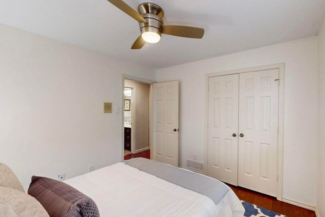 Bedroom with wood finished floors, a closet, and ceiling fan | Image 24