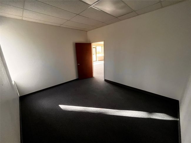 Spare room with a paneled ceiling and baseboards | Image 7