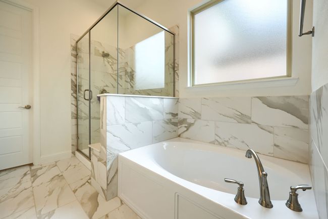 Full bath featuring marble finish floor, a garden tub, a marble finish shower, and baseboards | Image 19