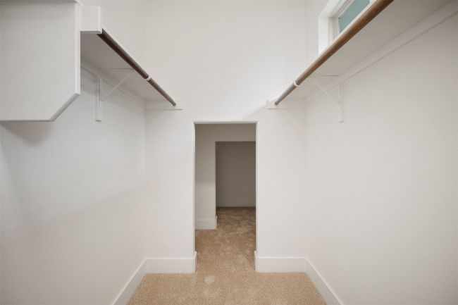 The walk-in closet offers generous space with additional storage at the back, making it easy to stay organized and store everything you need | Image 23