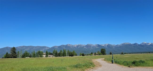 View of mountain backdrop with rural landscape | Image 26