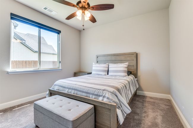 Carpeted bedroom with baseboards and ceiling fan | Image 33