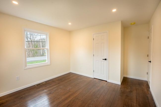 Unfurnished bedroom #2 featuring baseboards, dark wood finished floors, visible vents, and recessed lighting | Image 15