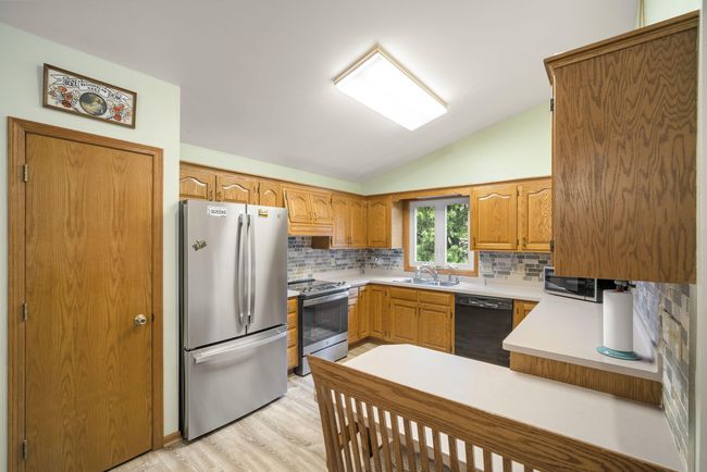 Enjoy a Modern Kitchen with New Backsplash, Newer Appliances, and Generous Dining Space! | Image 5