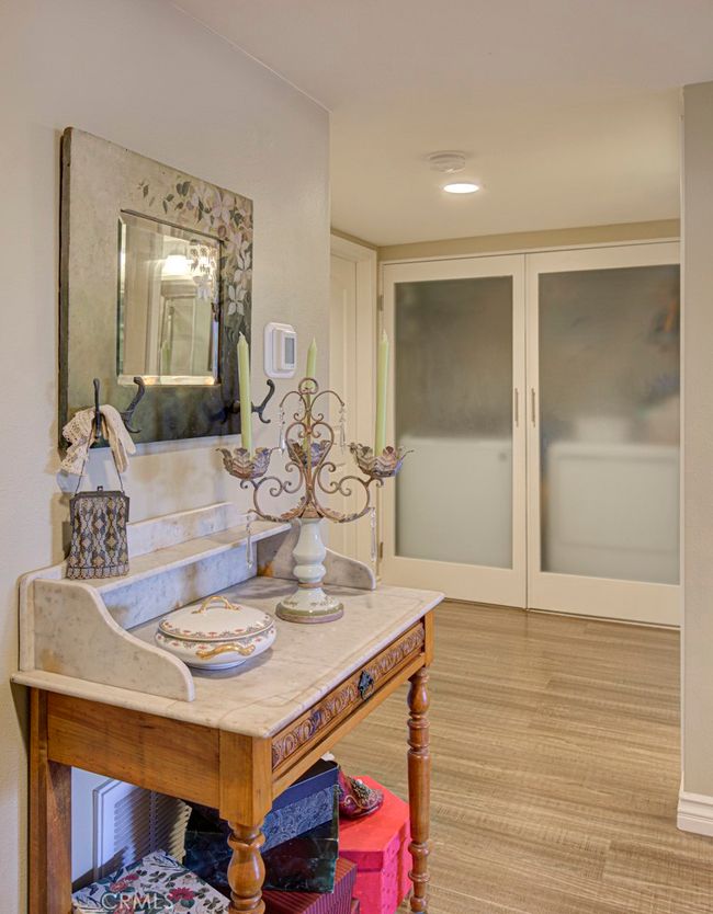 Hallway leading to the bedrooms and bathrooms. Full-sized washer-dryer are conveniently located behind opaque doors in the hall closet. | Image 18