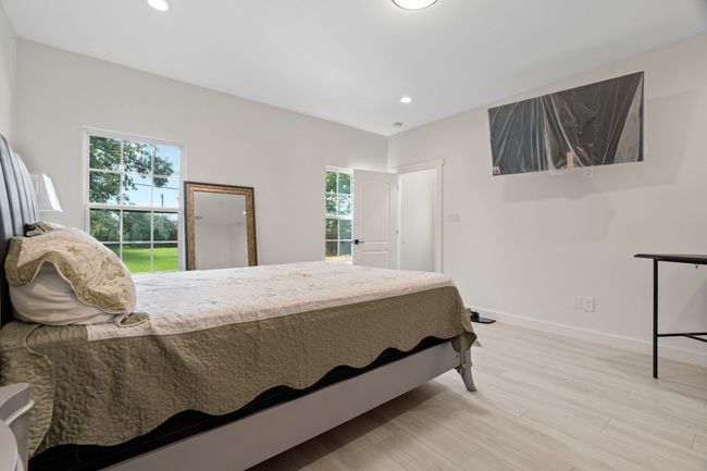 Bedroom featuring multiple windows, light wood-style flooring, and recessed lighting | Image 23