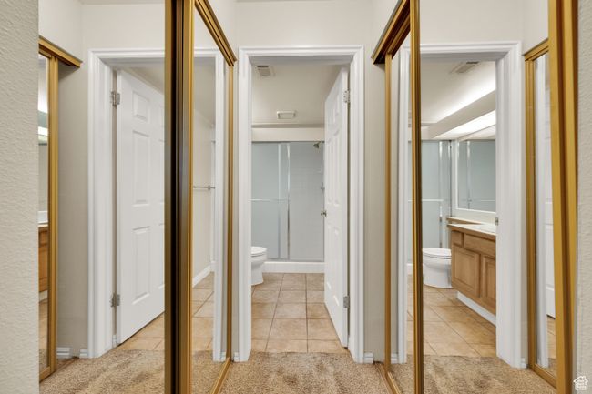Hallway featuring light tile patterned floors and light carpet | Image 9