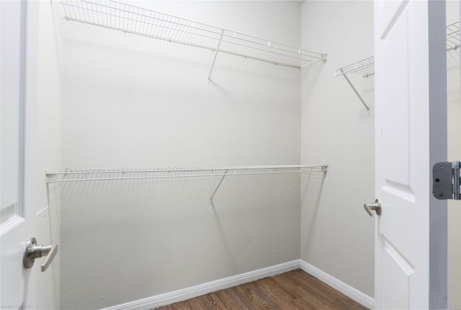 Spacious closet with wood finished floors | Image 22