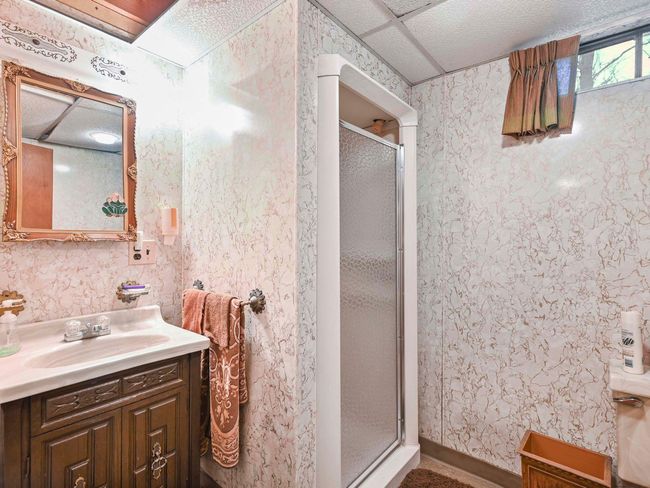 Bathroom with a drop ceiling, a shower with door, and vanity | Image 32