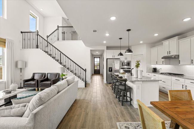 Living room featuring stairs, recessed lighting, and light wood-type flooring | Image 16