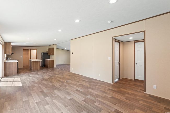 Unfurnished living room with recessed lighting and wood finished floors | Image 14