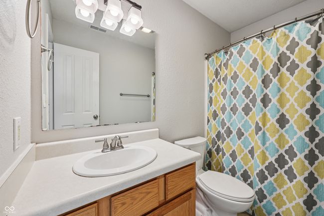 bathroom featuring vanity and curtained shower | Image 25
