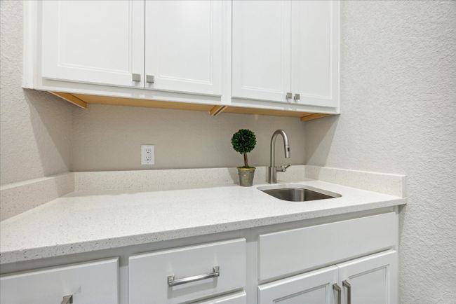 A full sink and lots of cabinet space make the utility room incredibly functional. | Image 38