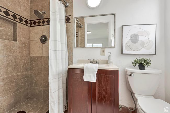 Bathroom with vanity, toilet, and a tile shower | Image 5
