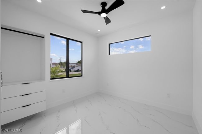 Unfurnished bedroom with recessed lighting, marble finish flooring, baseboards, and a ceiling fan | Image 5