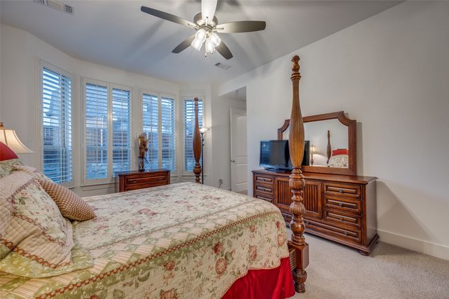 Carpeted bedroom featuring visible vents, baseboards, and ceiling fan | Image 14