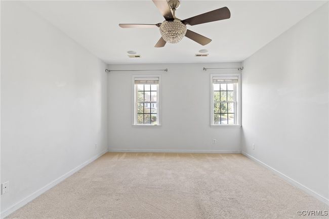 Unfurnished room featuring light colored carpet and ceiling fan | Image 18