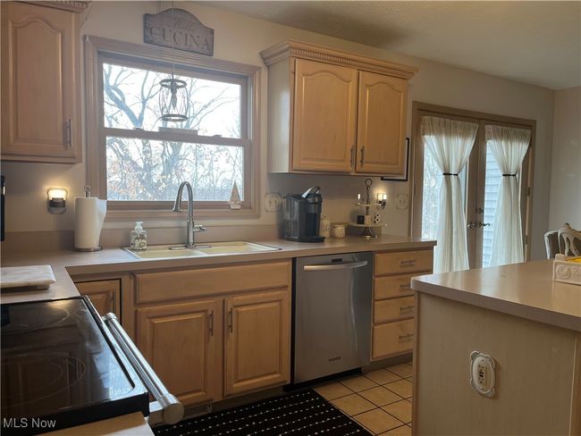 Kitchen with dishwasher, sink, and light brown cabinets | Image 15