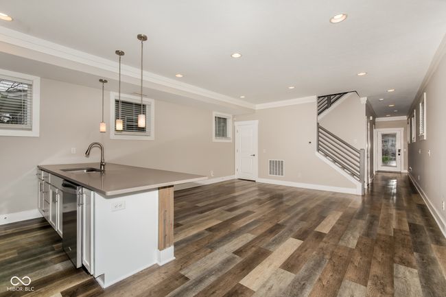 kitchen with a sink, decorative light fixtures, dark wood finished floors, visible vents, and recessed lighting | Image 16