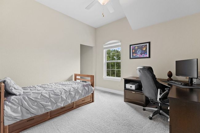 Bedroom with carpet, baseboards, a desk, and ceiling fan | Image 30