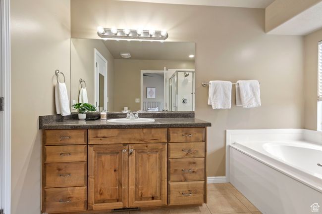 Bathroom with tile patterned flooring, vanity, and shower with separate bathtub | Image 12