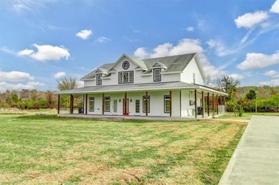 Farmhouse-style home with covered porch and a front lawn | Image 2