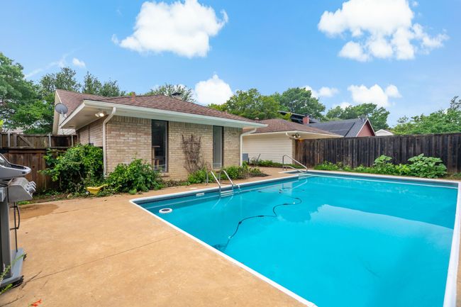 View of swimming pool with a fenced backyard, a fenced in pool, and a patio area | Image 30