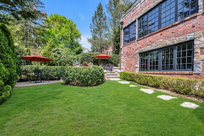 View of grassy yard with Multi Bluestone patio areas | Image 27
