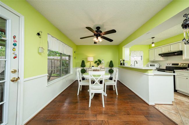 View into the breakfast room and kitchen area. | Image 8