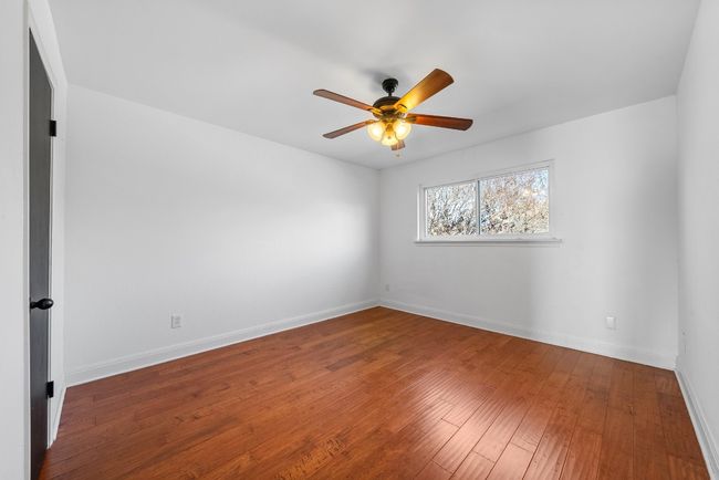 Bedroom with ceiling fan, wood-style flooring and spacious closet | Image 21