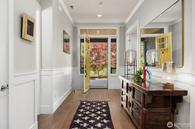 Powder room and coat closet on your left as you exit the home. | Image 15