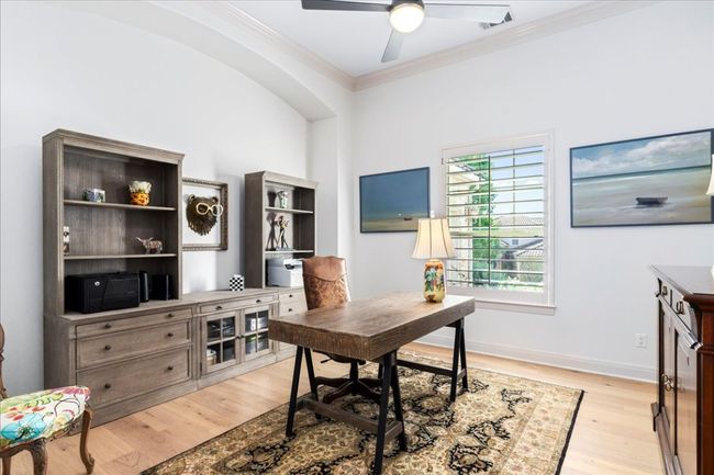 Home office featuring crown molding, light wood-type flooring, ceiling fan, and baseboards | Image 14
