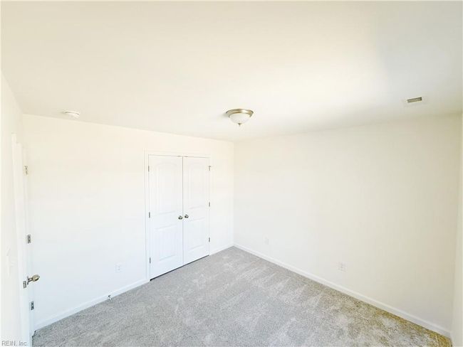 Upstairs you’ll find two additional bedrooms with carpet and double door closets. | Image 14