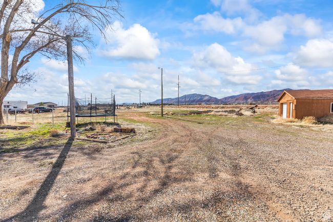 View of yard with a trampoline and a mountain view | Image 22