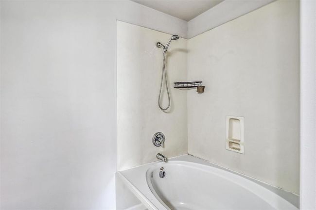 Across from the vanity, you'll find a tub/shower combination featuring an oversized soaking tub that is perfect for relaxing after a long day. | Image 23