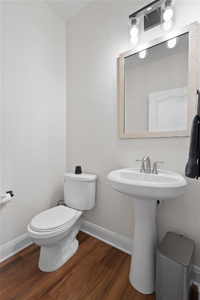 Bathroom featuring wood finished floors and toilet | Image 14