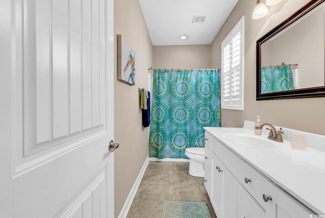 Bedroom with baseboards, wood finished floors, and a ceiling fan | Image 28