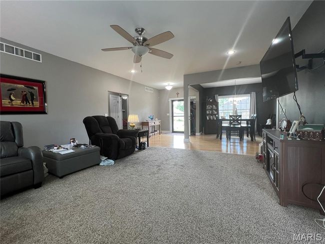 Living room with light colored carpet, ceiling fan, and recessed lighting | Image 19