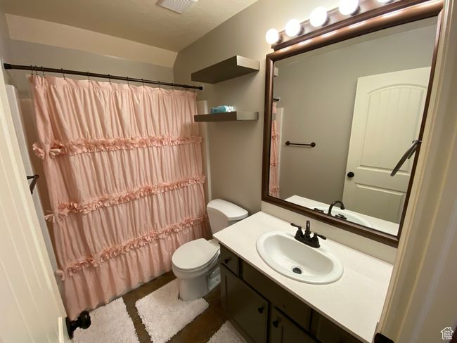 Full bathroom featuring toilet, vanity, and a shower with shower curtain | Image 20