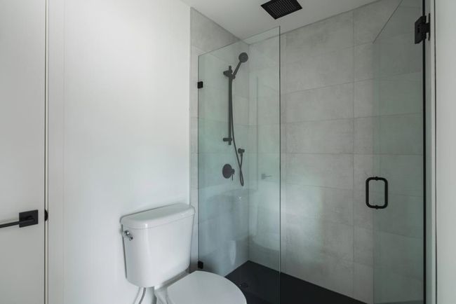 Full bathroom featuring a shower stall and toilet | Image 6