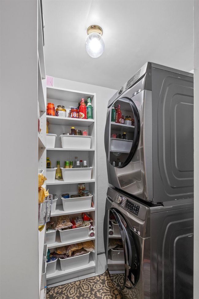 Laundry room with stacked washing machine and dryer | Image 12