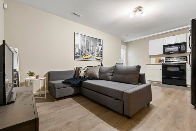 Living room featuring visible vents and light wood-type flooring | Image 25