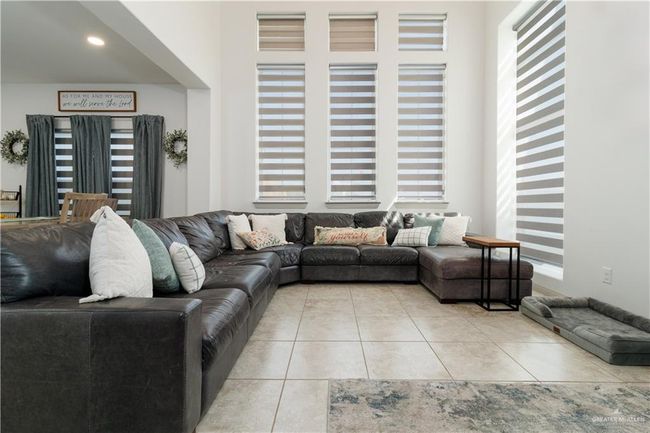 Living area featuring light tile patterned floors | Image 5