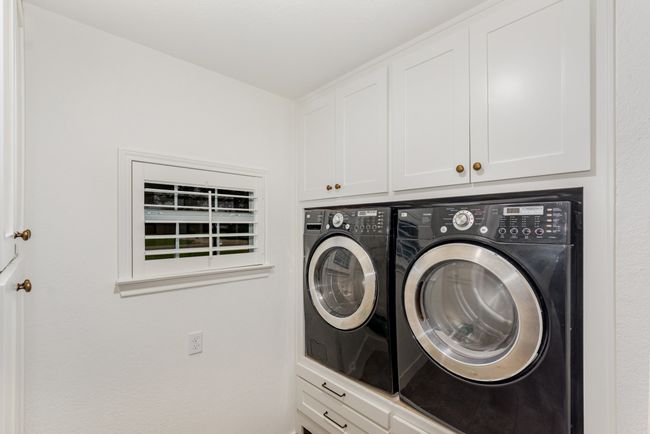 Laundry area with washer and clothes dryer and cabinet space | Image 27
