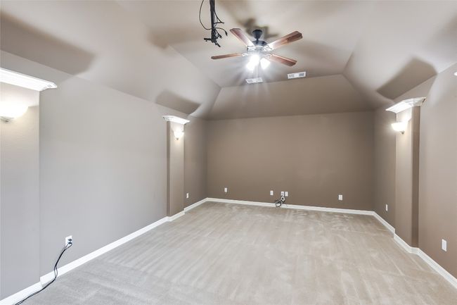Additional living space with baseboards, visible vents, lofted ceiling, and ceiling fan | Image 28