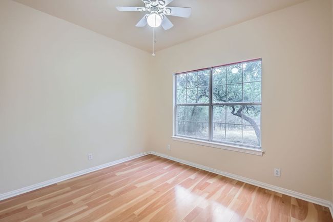 Unfurnished room with baseboards, light wood finished floors, and ceiling fan | Image 17