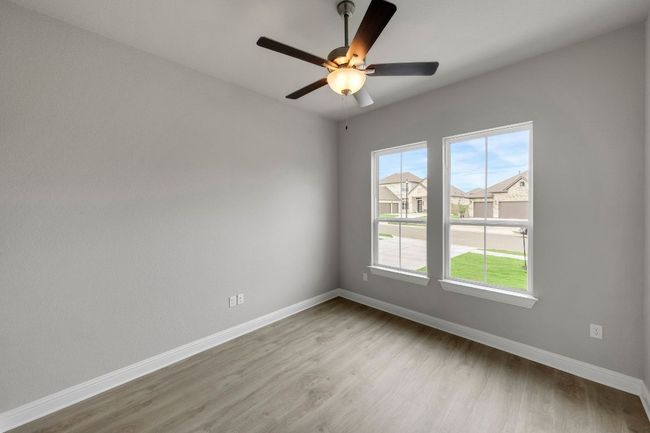 Unfurnished room featuring light wood-style floors, ceiling fan, and a residential view | Image 20