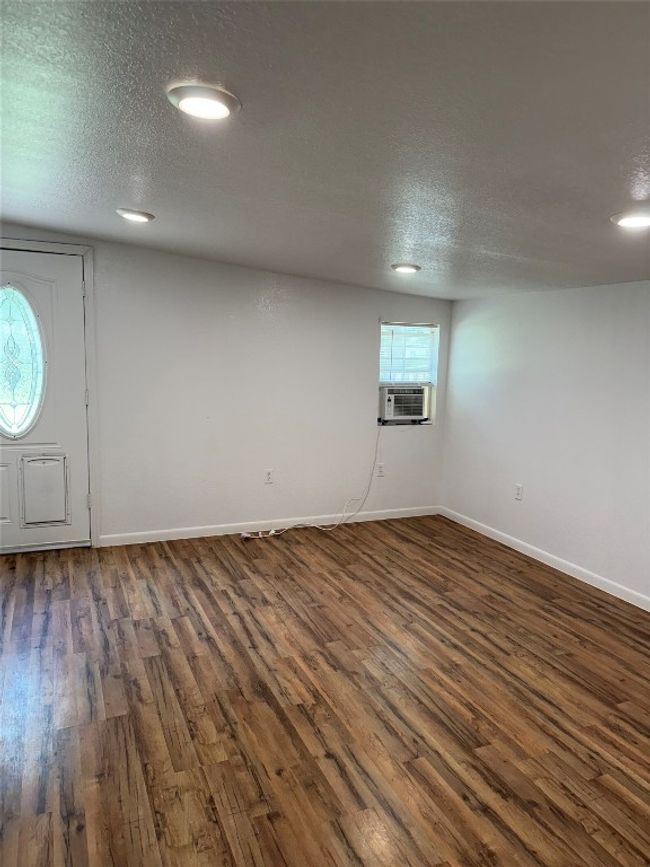 Entryway with dark wood finished floors, cooling unit, recessed lighting, and a textured ceiling | Image 9